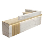 Left high return marble reception desk showing fluted panel and structured workstation area