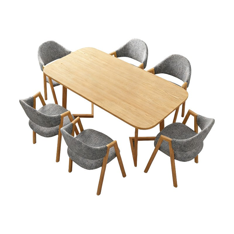 Natural wood dining table with six charcoal chairs, featuring a modern Scandinavian design for dining rooms and flexible workspaces